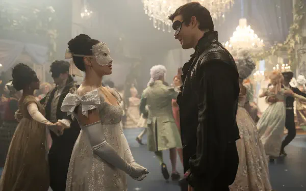 Masked couple converse in an opulent Bridgerton ballroom, chandeliers and costumed dancers behind them — 5K Ultra HD PC desktop wallpaper.