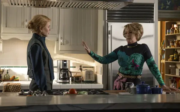 2K TV-show desktop wallpaper: scene from Scarpetta—two women in a modern kitchen, one gesturing toward the other during a tense conversation.