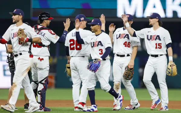 World Baseball Classic — USA Baseball team celebrates on the field in white uniforms, high-fiving teammates; 2K Quad HD PC desktop wallpaper background, baseball sports image.