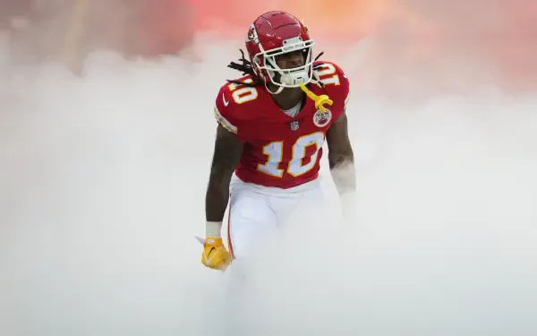 Kansas City Chiefs player in red No. 10 jersey emerging through thick smoke — 2K Quad HD PC desktop wallpaper background.