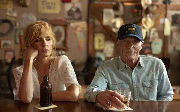 Two TV-show characters at Dutton Ranch sit at a bar—woman with a beer bottle and man in a cap holding a glass. 4K Ultra HD PC desktop wallpaper/background.