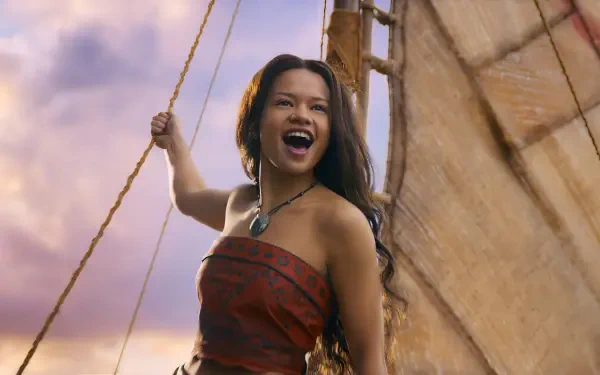 Live-action Moana movie HD PC desktop wallpaper: young woman on a sailboat, hair blowing, laughing against a warm golden sky.