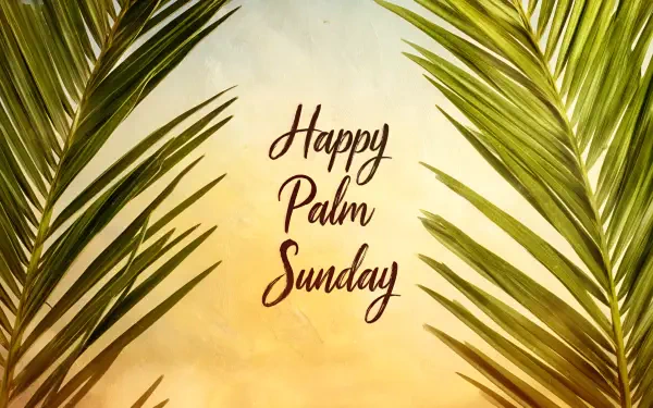 Religious Palm Sunday 2K Quad HD PC desktop wallpaper: warm sunrise background framed by palm fronds with centered Happy Palm Sunday script.