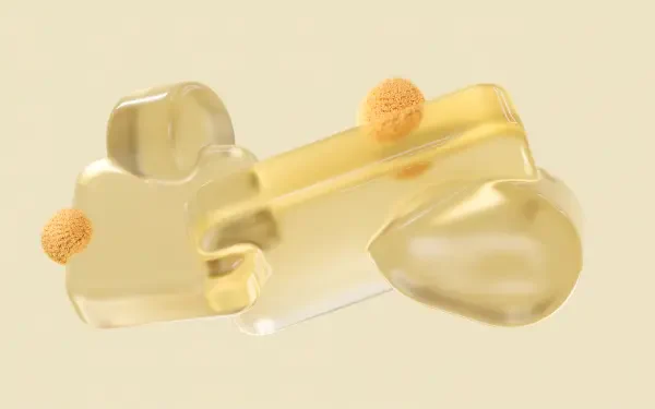 Microsoft abstract yellow pastel 4K Ultra HD PC desktop wallpaper: glossy translucent organic forms with small fuzzy orange spheres on a pale backdrop.