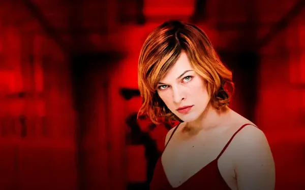 Resident Evil 4K Ultra HD PC desktop wallpaper: red-hued corridor with a determined female protagonist in a red dress, direct stare and dramatic cinematic lighting.