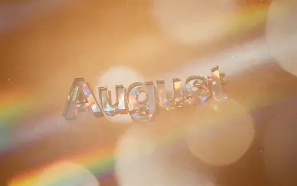 Translucent August lettering over warm golden bokeh and prism rainbows — 4K Ultra HD PC desktop wallpaper/background.