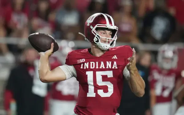 4K Ultra HD PC wallpaper of a football quarterback in a red Indiana jersey No. 15 winding up to throw amid a packed stadium — sports/NFL themed desktop background.