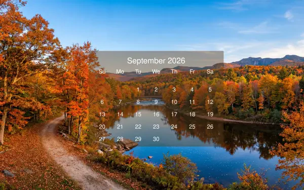 September 2026 calendar over a 5K Ultra HD PC desktop wallpaper and background: autumn lakeside with vibrant foliage, a winding dirt path and trees mirrored in the calm water.