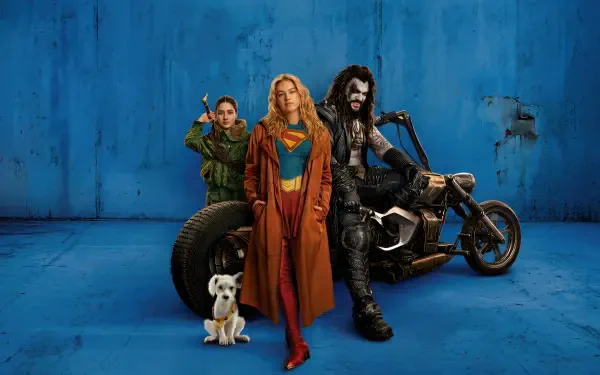 Supergirl (2026) 4K Ultra HD PC desktop wallpaper: Supergirl in red-and-blue suit and leather jacket stands center, flanked by an archer ally, a leather-clad biker on a motorcycle, and a small dog.