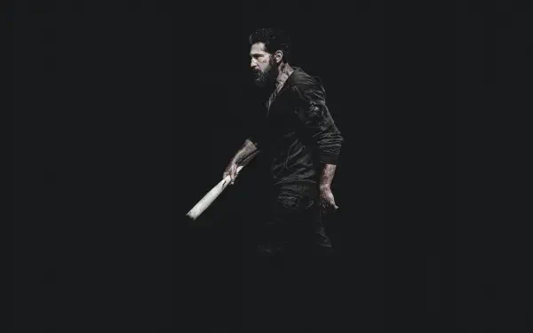 4K Ultra HD PC desktop wallpaper — The Punisher: One Last Kill: lone vigilante in dark clothes gripping a bat, emerging from deep black background.