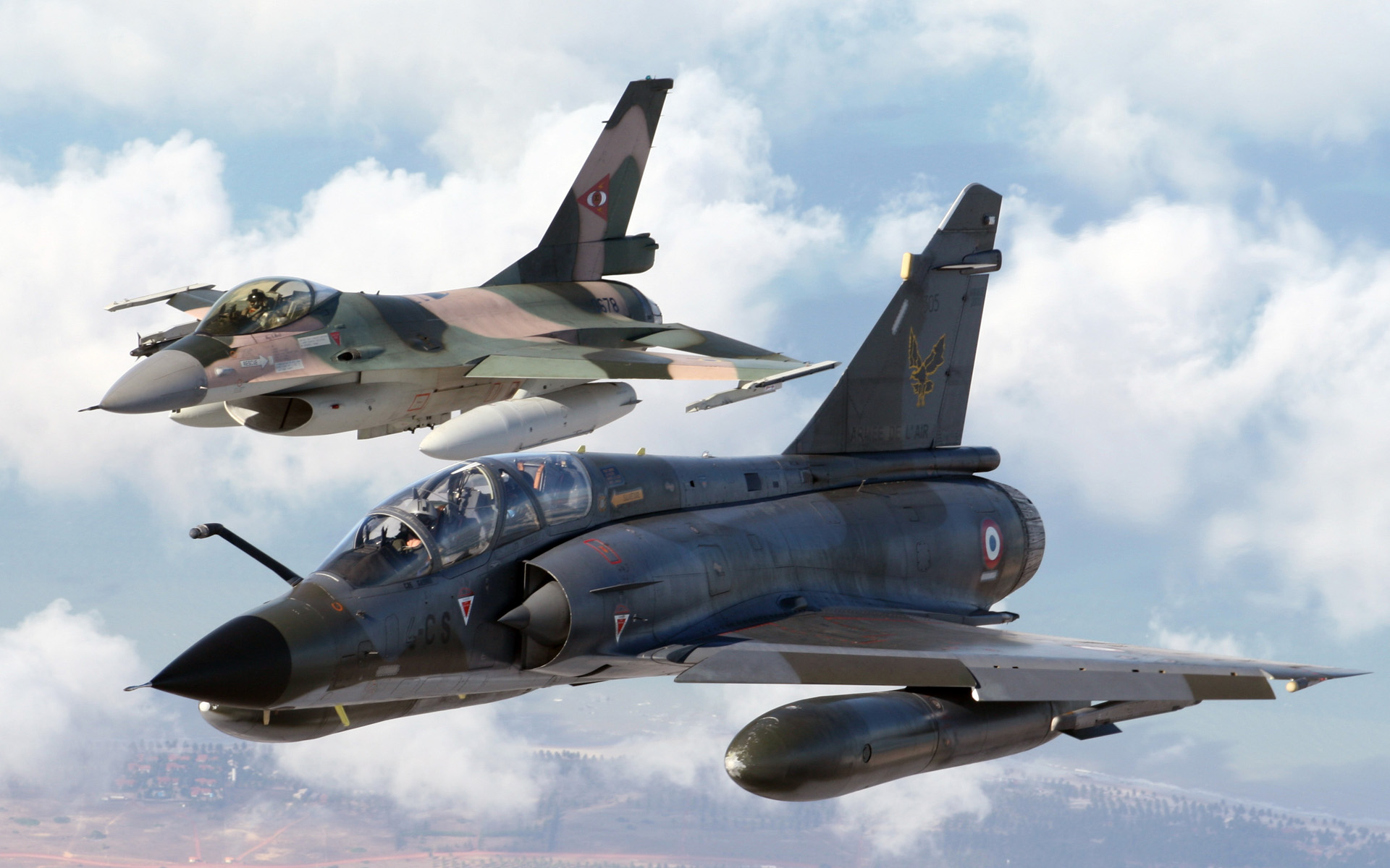 Mirage and Fighting Falcon soaring through the sky, a powerful duo of military jet fighters.