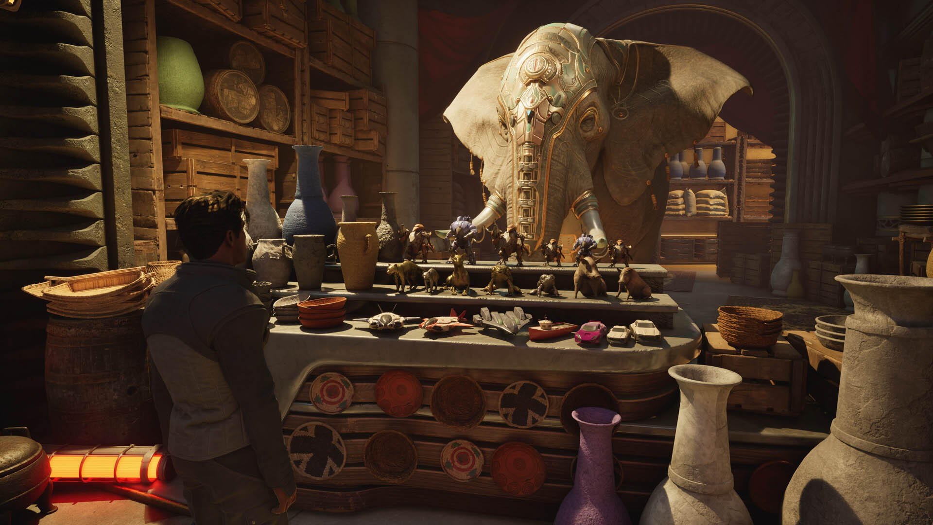 HD PC desktop wallpaper — Exodus (2027) video game: a market stall with a giant elephant head, rows of pottery and figurines, and a lone shopper amid warm, dim light.