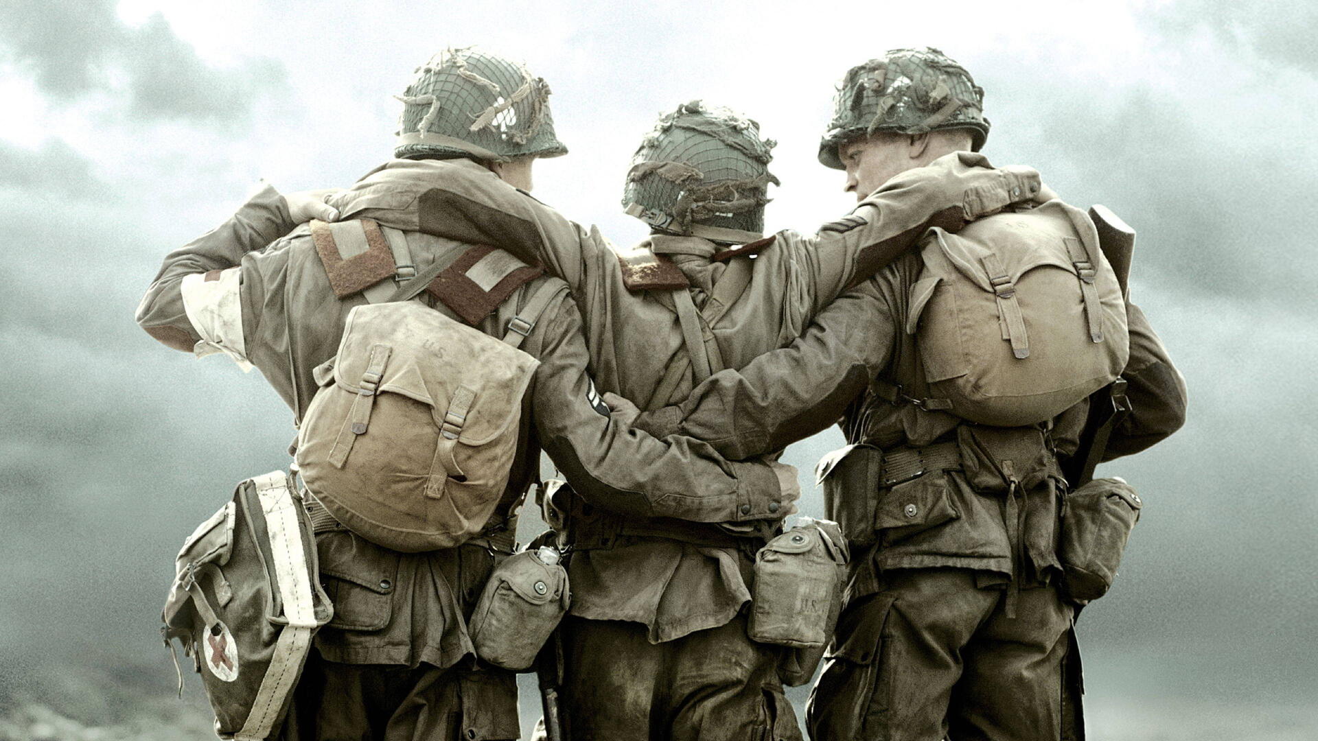 Band of Brothers 4K Ultra HD PC desktop wallpaper and background: three WWII soldiers in worn gear with arms linked, walking away under a cloudy, muted sky.