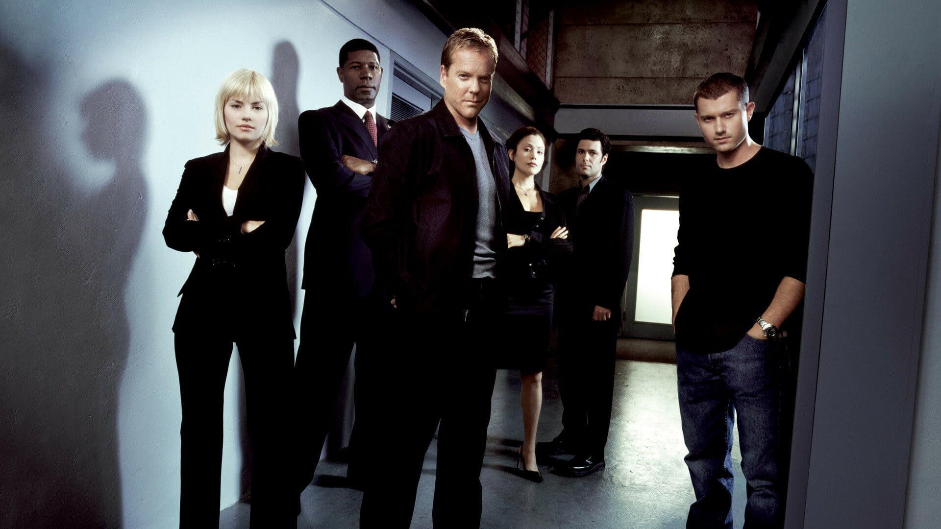 HD PC desktop wallpaper background — tag 24: moody corridor scene with six serious-looking figures in dark clothing standing under stark lighting, casting long shadows.