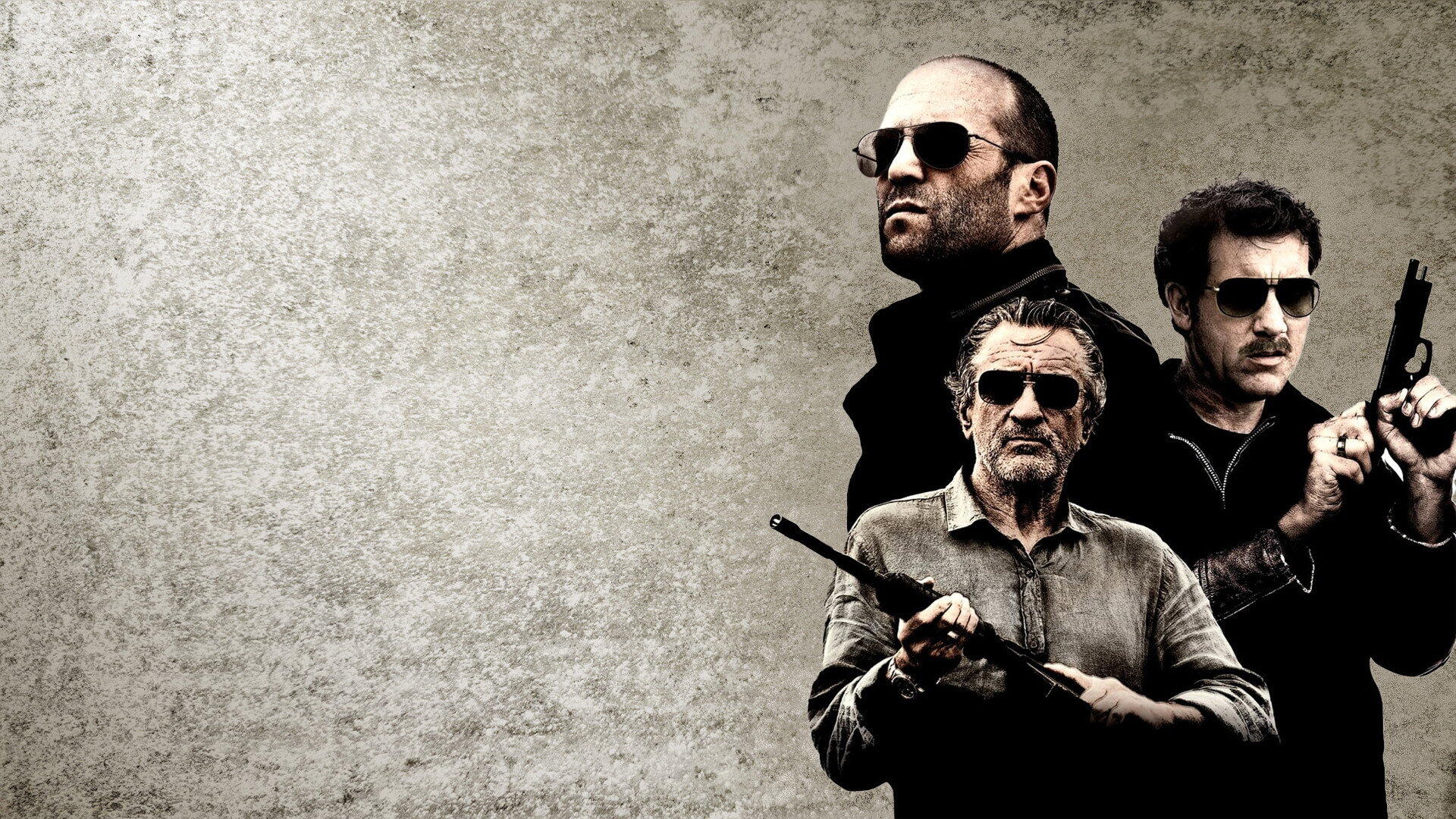 Killer Elite HD PC desktop wallpaper: three armed men in dark clothing and sunglasses clustered at right against a textured gray background.