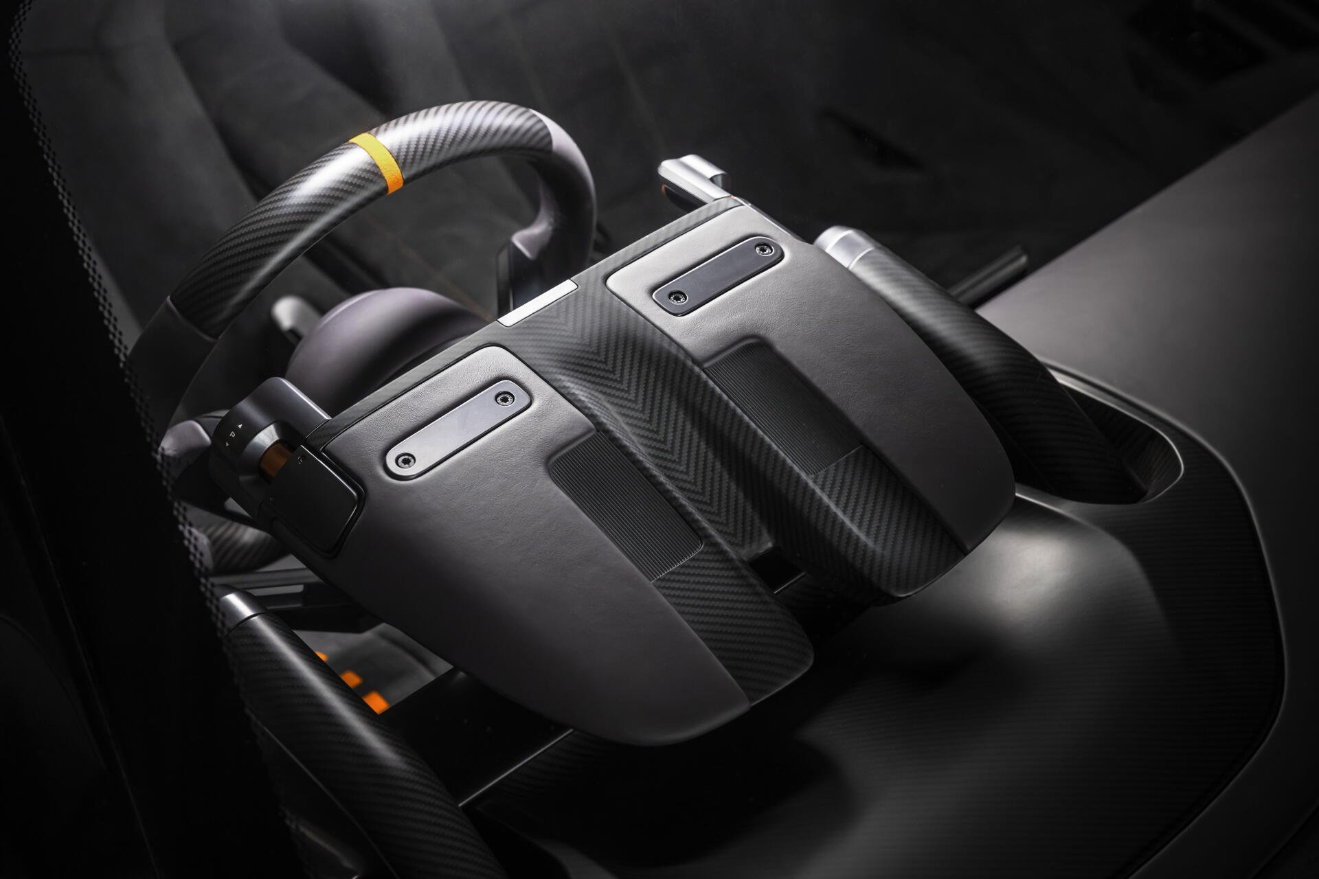 Close-up of McLaren McL 6GT vehicle controller-style center console in 8K Ultra HD PC desktop wallpaper, showing carbon-fiber paddles and ergonomic controls.