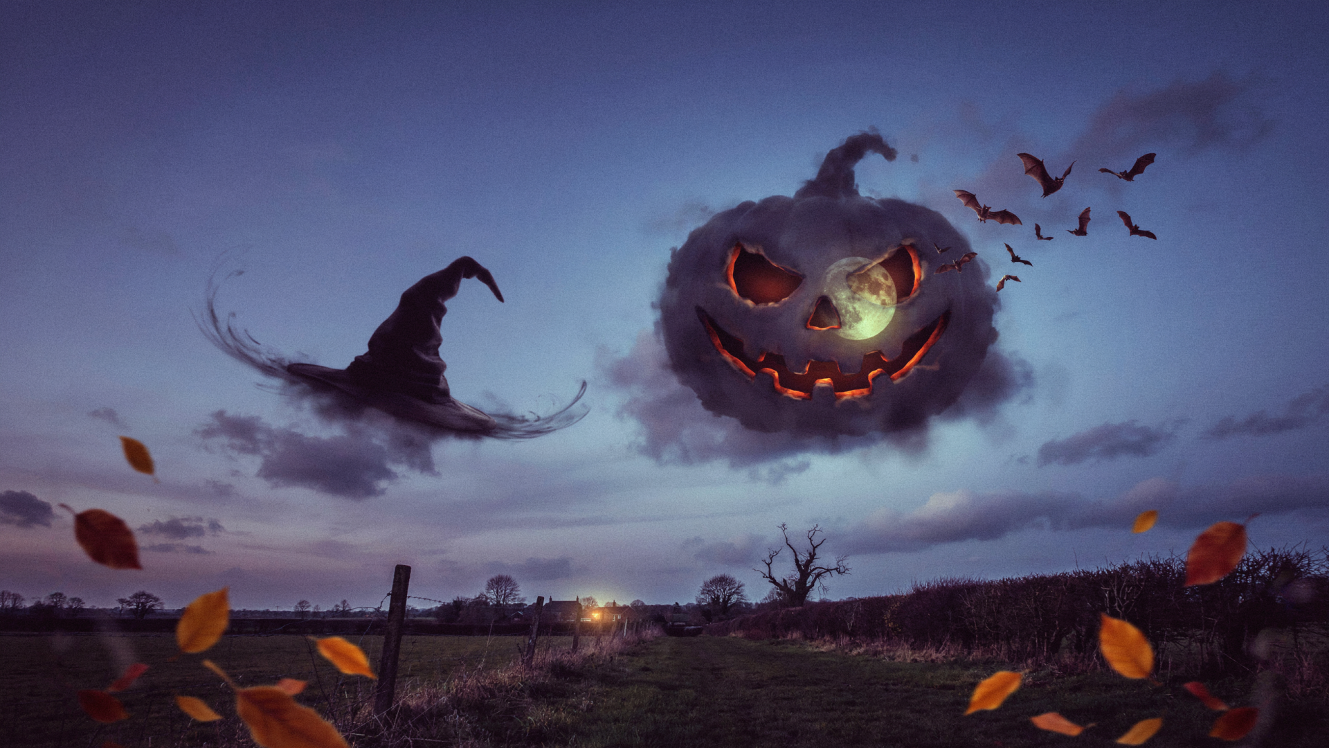 2K Quad HD PC desktop wallpaper: Halloween aesthetic with a floating pumpkin jack-o'-lantern face in a stormy sky, bats and falling leaves above a lonely fence.