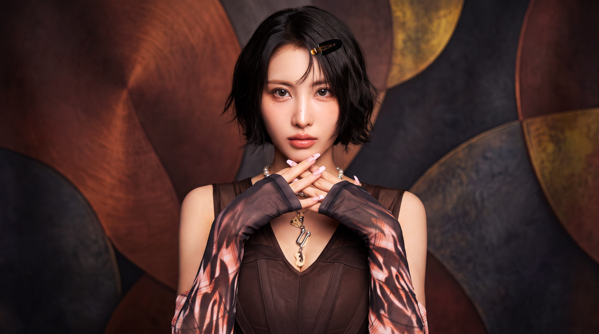 Close-up portrait of a short-haired woman posed like a k-pop idol/Japanese model, wearing patterned gloves and a dark dress against a warm abstract backdrop; 5K desktop wallpaper.