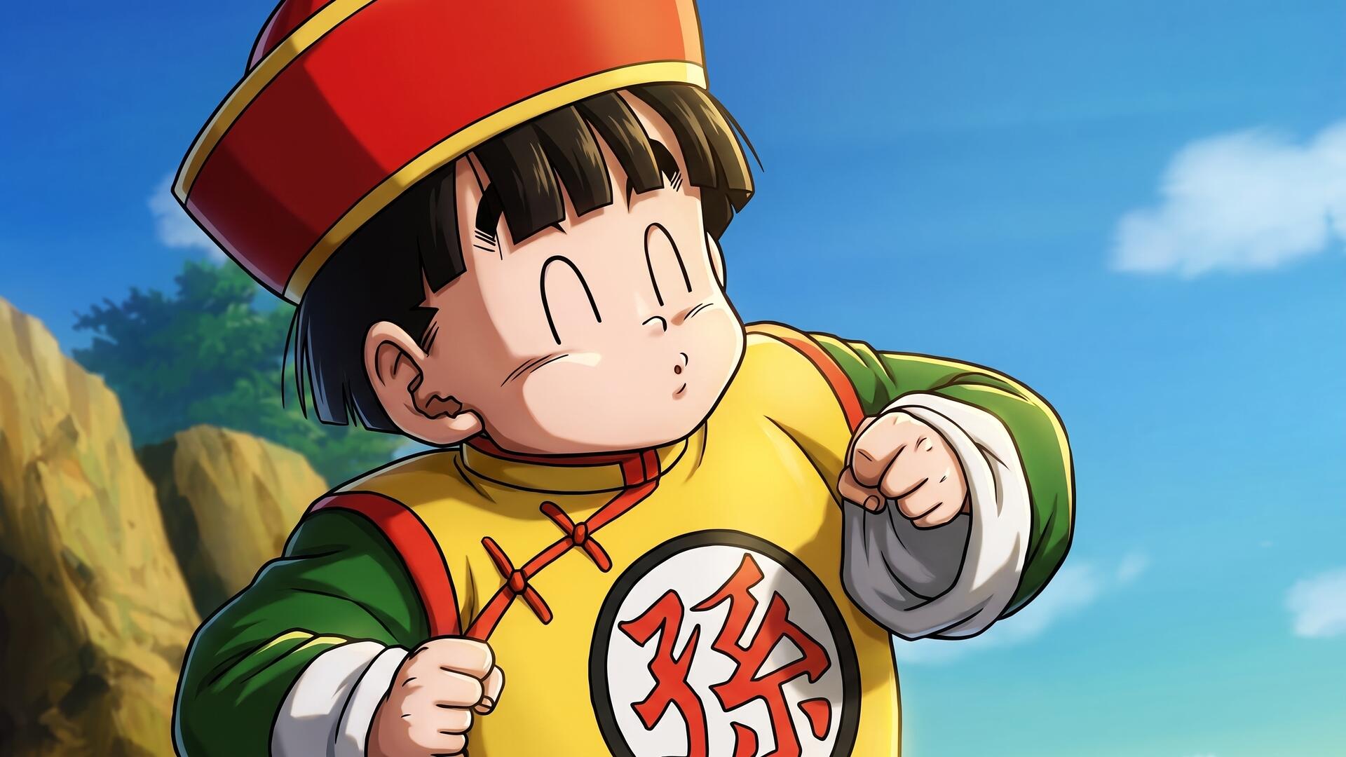 HD PC desktop wallpaper: Dragon Ball Z anime of Gohan (Dragon Ball) as a child in a yellow-green traditional outfit and red hat, smiling against a bright blue sky and rocky hillside.
