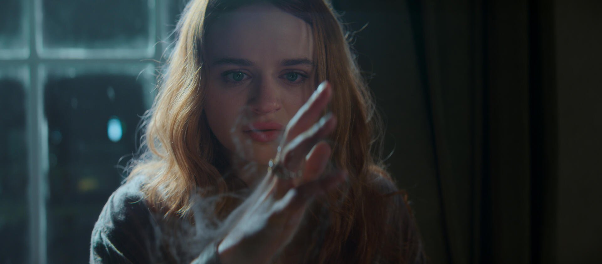 Cinematic portrait of a young woman touching a pane of glass with an outstretched hand, soft backlight and moody tones; 2K Quad HD PC desktop wallpaper/background.