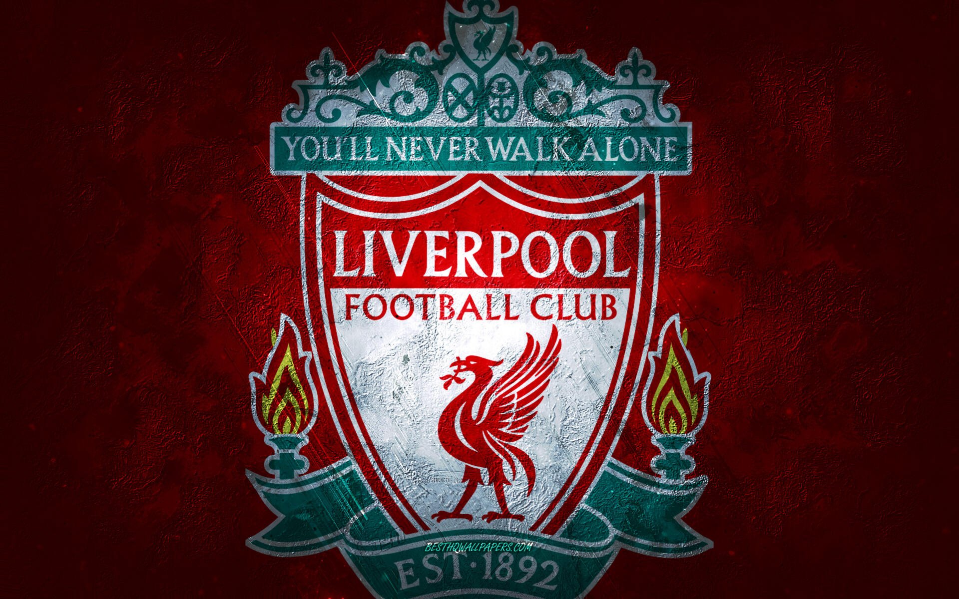 Liverpool F.C. crest on a deep red textured background with torches and You'll Never Walk Alone banner — 2K Quad HD PC desktop wallpaper.