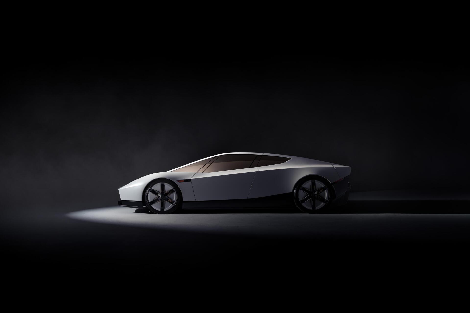 Tesla Roadster concept car in a sleek side profile against a dark studio backdrop, 2K Quad HD PC desktop wallpaper and background.
