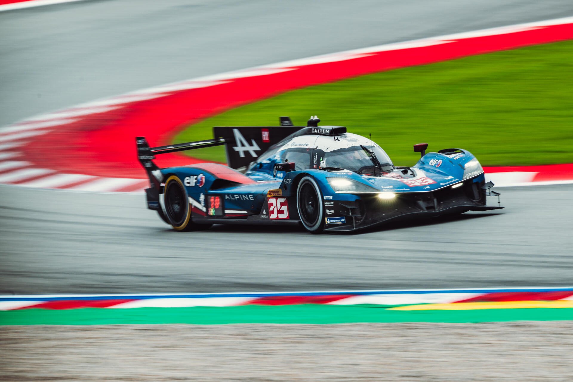 Alpine A424 race car speeding around a race track in motorsport action, featured in a 5K Ultra HD PC desktop wallpaper background.