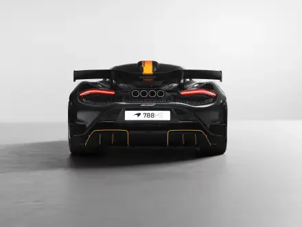 8K Ultra HD PC desktop wallpaper: rear view of a black McLaren 788HS vehicle with glowing taillights, orange racing stripe, and minimalist gray background.