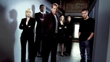 HD PC desktop wallpaper background — tag 24: moody corridor scene with six serious-looking figures in dark clothing standing under stark lighting, casting long shadows.
