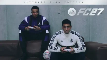 2K Quad HD PC desktop wallpaper showing two gamers in Real Madrid tracksuits holding controllers on a couch, a soccer ball at their feet and the EA SPORTS FC 27 logo behind them.