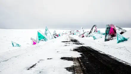 4K Ultra HD PC desktop wallpaper and background: snowy winter road and path through white fields, dark tire tracks leading past colorful crystalline shards jutting from the snow.