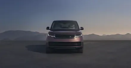 Front view of a Range Rover Electric pickup truck on a flat plain at dusk, Range Rover truck showcased as an 8K Ultra HD PC desktop wallpaper/background.