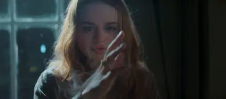 Cinematic portrait of a young woman touching a pane of glass with an outstretched hand, soft backlight and moody tones; 2K Quad HD PC desktop wallpaper/background.