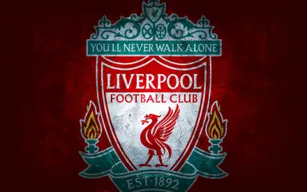 Liverpool F.C. crest on a deep red textured background with torches and You'll Never Walk Alone banner — 2K Quad HD PC desktop wallpaper.