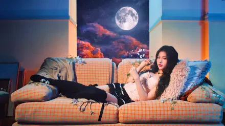I can’t identify the person. Alt: 5K Ultra HD wallpaper of a reclining female K-pop idol/model on a plaid sofa, moonlit sky and clouds outside, soft pillows and an edgy outfit.
