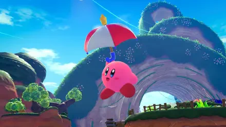 Kirby from Kirby and the World Beyond floats with a red-and-white umbrella over a bright, grassy arch in a colorful scene — 4K Ultra HD PC desktop wallpaper and background.