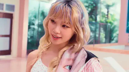 Smiling blonde woman in pastel K-pop–inspired outfit with striped jacket, sunlit tropical indoor background — 5K Ultra HD PC desktop wallpaper.