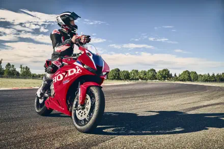 Motorcyclist on a red Honda CBR600RR at a racetrack, 5K Ultra HD PC desktop wallpaper and background.