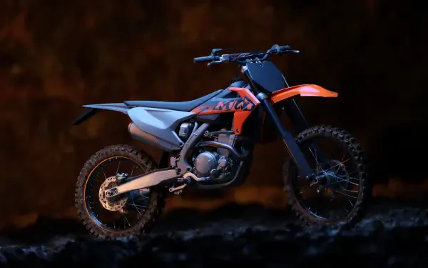 Orange and black dirt bike side profile on dark textured ground with dramatic lighting — 5K Ultra HD PC desktop wallpaper and background.