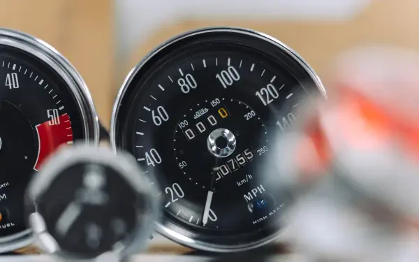 8K Ultra HD PC desktop wallpaper of a vehicle: close-up McLaren G6GT dashboard with speedometer, odometer and instrument gauges.