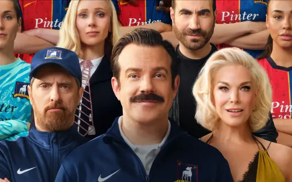 Ted Lasso 4K Ultra HD desktop wallpaper — mustached coach smiling center, surrounded by teammates and staff in team jerseys against a stadium backdrop.