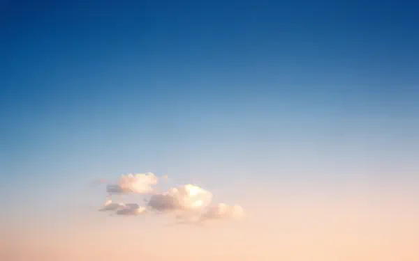 4K Ultra HD PC desktop wallpaper and background: expansive clear sky gradient from deep blue to soft peach with a single fluffy cloud near the horizon.