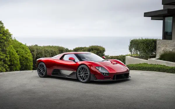 Red McLaren McL 6GT supercar sports car parked by a modern house, 8K Ultra HD PC desktop wallpaper background.