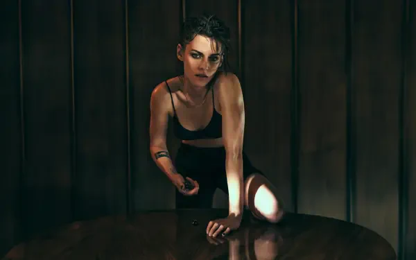 Cinematic portrait of a woman leaning on a table in low light with dramatic shadows — 5K Ultra HD PC desktop wallpaper and background