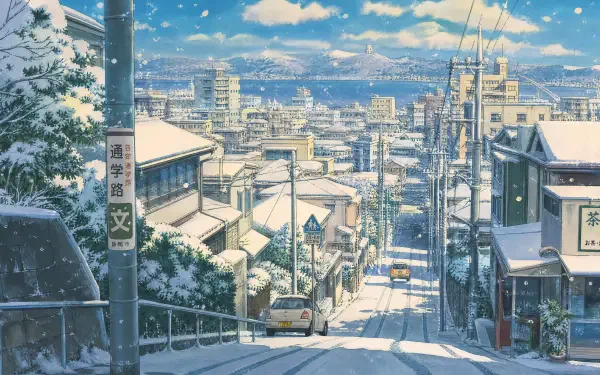 4K Ultra HD PC desktop wallpaper background: snow-covered urban street descending into a winter cityscape, rooftops, streetcars and distant skyline under falling snow.