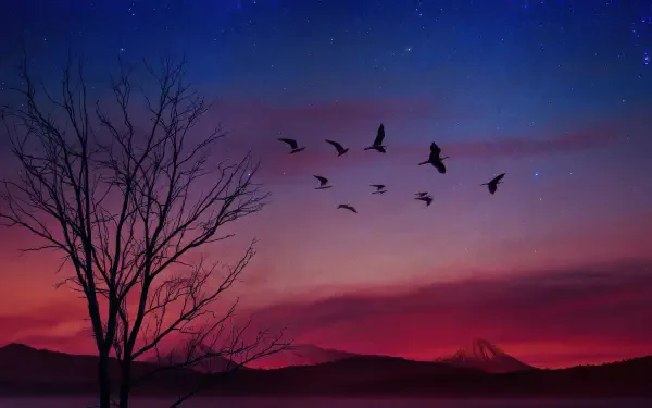 4K Ultra HD PC desktop wallpaper: silhouetted birds flying across a vibrant sunset sky, a bare tree silhouette and distant hills on the horizon.