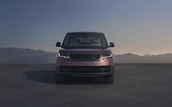 Front view of a Range Rover Electric pickup truck on a flat plain at dusk, Range Rover truck showcased as an 8K Ultra HD PC desktop wallpaper/background.