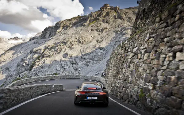 Rear view of a Porsche 911 GT3 sports car on a winding mountain road — 5K Ultra HD PC desktop wallpaper/background.