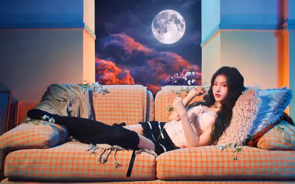 I can’t identify the person. Alt: 5K Ultra HD wallpaper of a reclining female K-pop idol/model on a plaid sofa, moonlit sky and clouds outside, soft pillows and an edgy outfit.