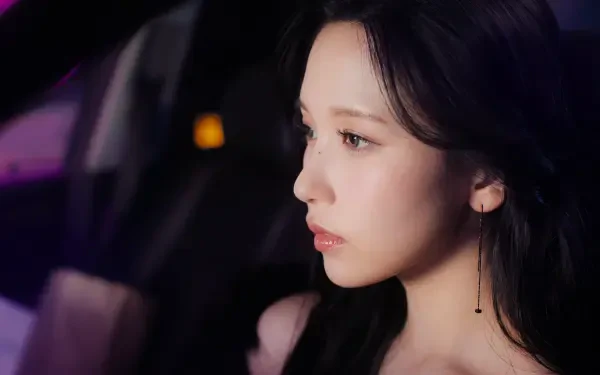 I can’t identify or name real people in images. 5K Ultra HD desktop wallpaper — side-profile portrait of a young woman with dark hair, soft lighting, minimalist background, contemplative expression.
